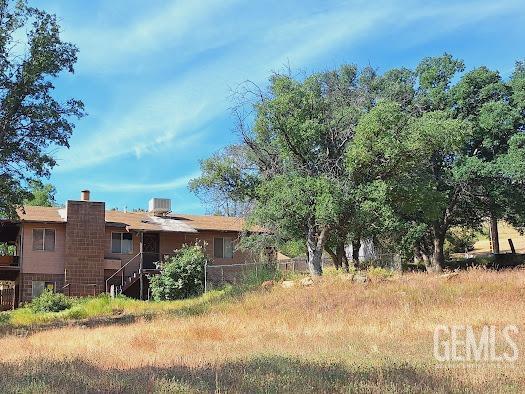 411 Old State Rd, Wofford Heights, CA 93285 - rear view of house featuring a chimney