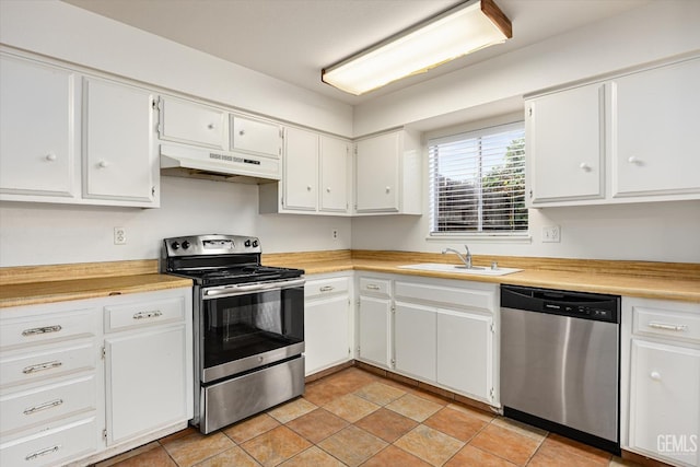 kitchen with appliances with stainless steel finishes, a sink, white cabinetry, and under cabinet range hood