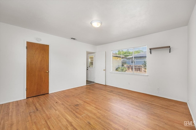 3201 Pomona St, Bakersfield, CA 93305 - empty room with light wood-style flooring and a smoke detector