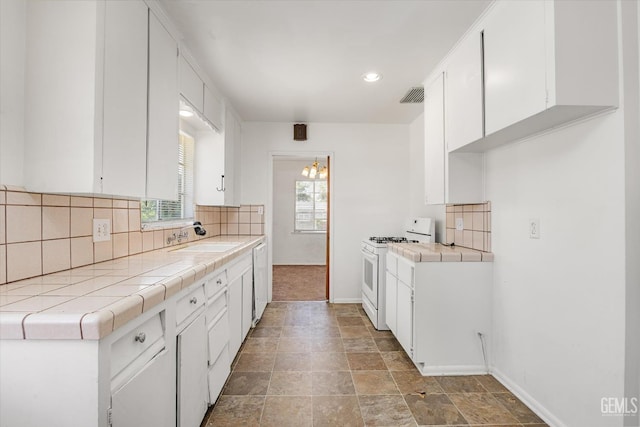 3201 Pomona St, Bakersfield, CA 93305 - kitchen featuring white range with gas cooktop, tile counters, tasteful backsplash, and recessed lighting