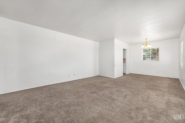3201 Pomona St, Bakersfield, CA 93305 - carpeted empty room featuring a chandelier