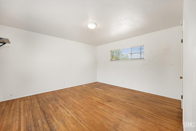 3201 Pomona St, Bakersfield, CA 93305 - empty room featuring wood finished floors and baseboards