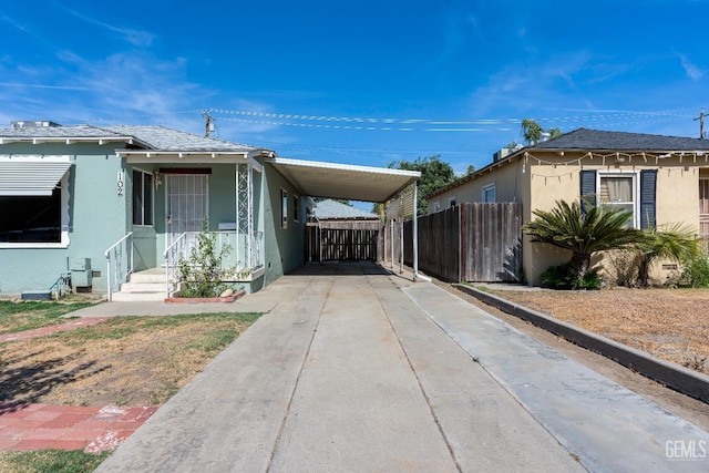102 Wetherley Dr, Bakersfield, CA 93309 - view of home's exterior featuring stucco siding, concrete driveway, and a carport