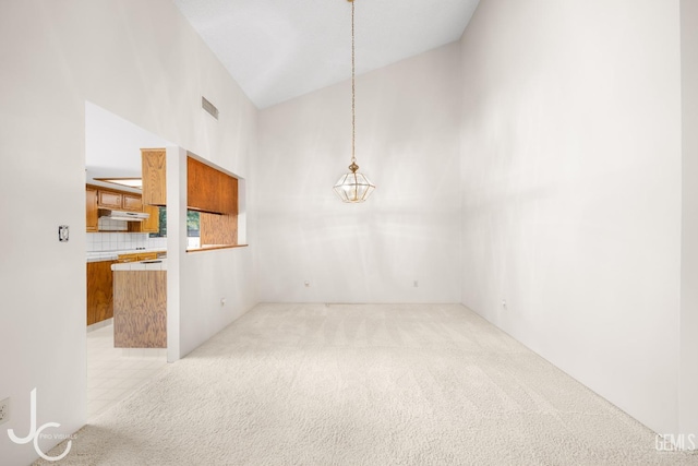 interior space with visible vents, a chandelier, and light colored carpet