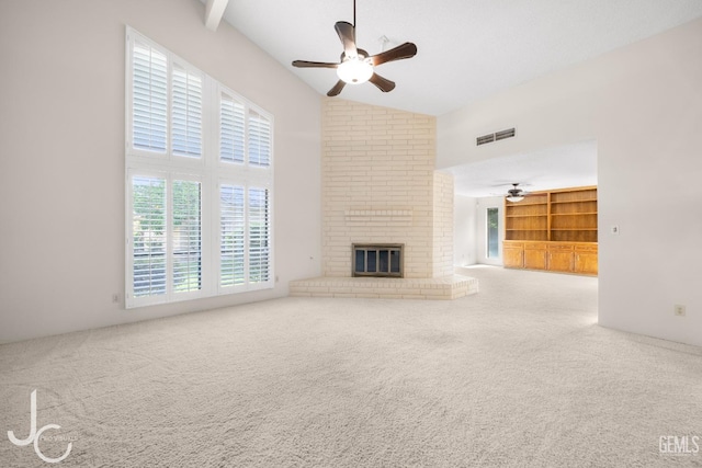 unfurnished living room featuring a ceiling fan, visible vents, and carpet