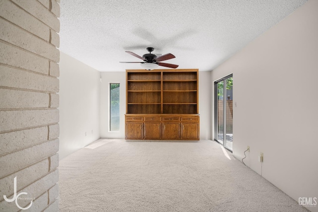 interior space featuring a textured ceiling and ceiling fan