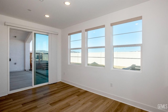 unfurnished room with wood-type flooring