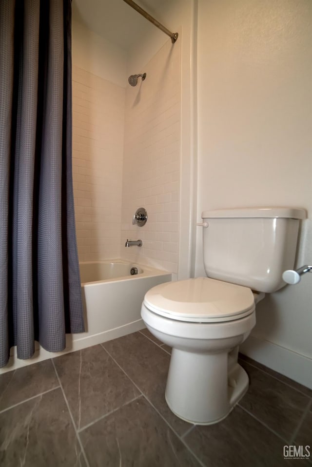 bathroom featuring toilet, shower / bathtub combination with curtain, and tile patterned flooring