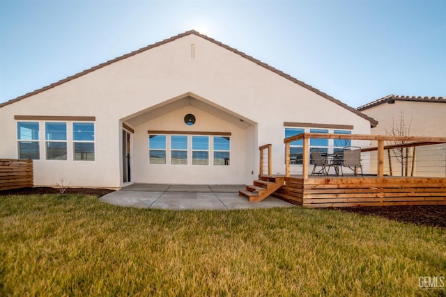 back of house featuring a yard and a patio area