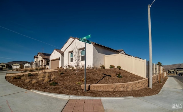 view of side of home featuring a garage