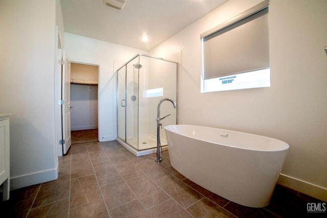 bathroom with tile patterned floors and shower with separate bathtub