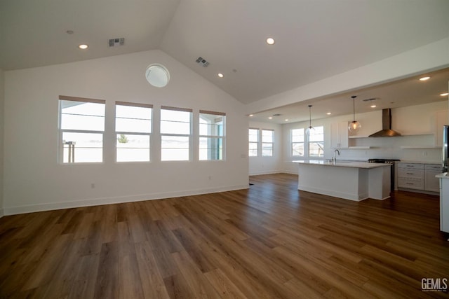 unfurnished living room with sink, dark wood-type flooring, and vaulted ceiling