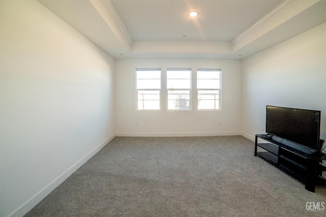 interior space featuring ornamental molding, light carpet, and a tray ceiling