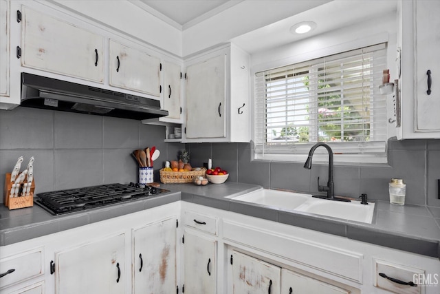 5906 Ronald Way, Bakersfield, CA 93308 - kitchen featuring black gas stovetop, under cabinet range hood, backsplash, and white cabinetry