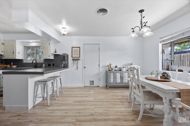5906 Ronald Way, Bakersfield, CA 93308 - dining area with light wood-style floors and a chandelier