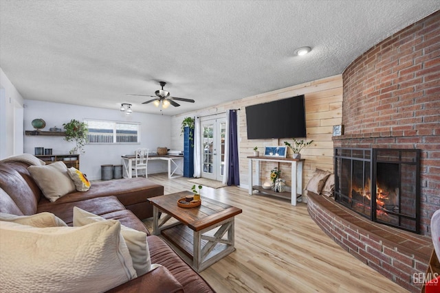 5906 Ronald Way, Bakersfield, CA 93308 - living room with a textured ceiling, a ceiling fan, wood finished floors, and a fireplace