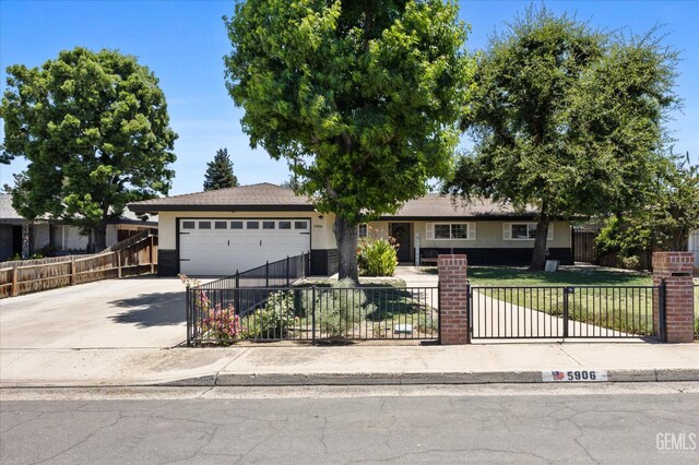 5906 Ronald Way, Bakersfield, CA 93308 - ranch-style house featuring an attached garage, stucco siding, concrete driveway, and a fenced front yard