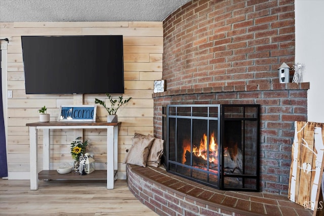 5906 Ronald Way, Bakersfield, CA 93308 - living area with a fireplace, a textured ceiling, wood finished floors, and wood walls