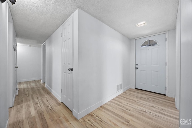 5906 Ronald Way, Bakersfield, CA 93308 - foyer entrance with light wood-style floors and a textured ceiling