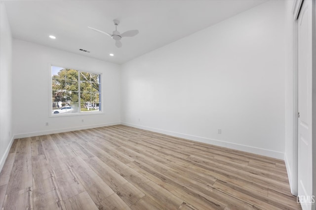 empty room featuring ceiling fan and light hardwood / wood-style floors