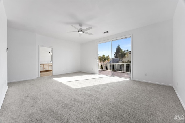 spare room with light carpet and ceiling fan