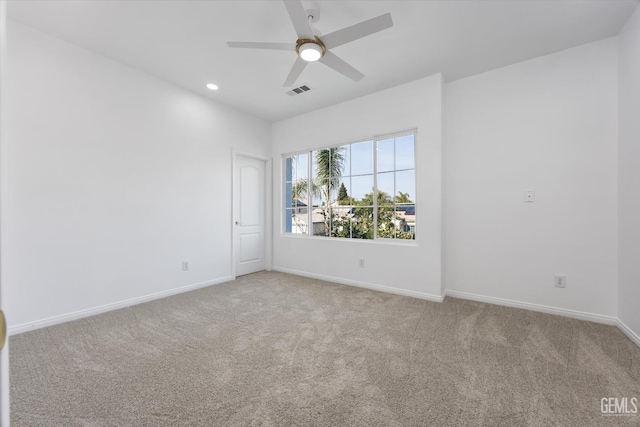 spare room with light carpet and ceiling fan