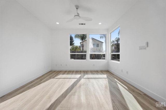 empty room featuring ceiling fan and light hardwood / wood-style floors