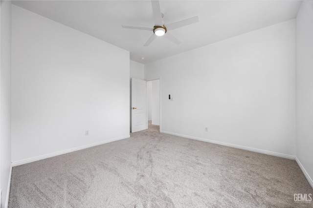 empty room featuring ceiling fan and carpet