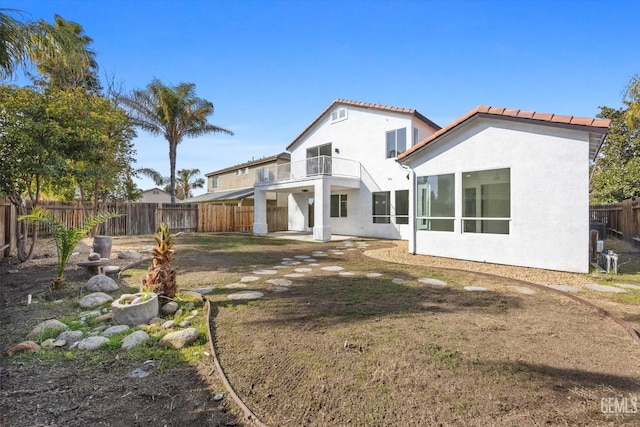 back of property with a balcony