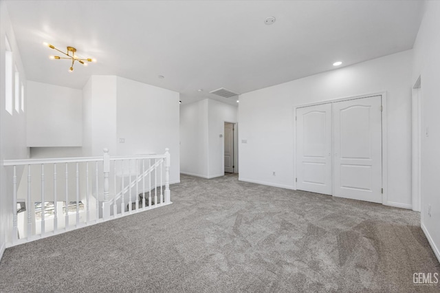 spare room featuring carpet flooring and a wealth of natural light