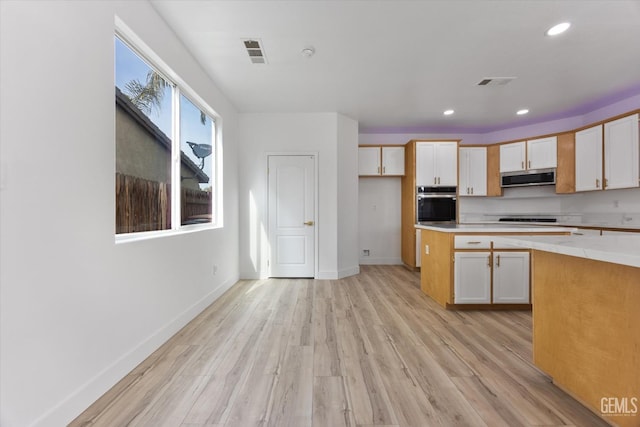 kitchen with appliances with stainless steel finishes and light wood-type flooring