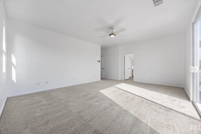 carpeted spare room with ceiling fan