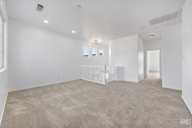 unfurnished room with light colored carpet