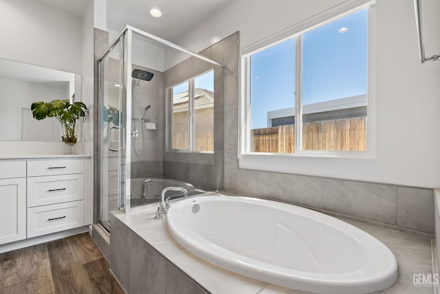 713 Winooski Ct, Bakersfield, CA 93314 - full bathroom with a garden tub, a shower stall, wood finished floors, vanity, and recessed lighting