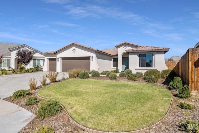 713 Winooski Ct, Bakersfield, CA 93314 - view of front of property with an attached garage, concrete driveway, stucco siding, and a tile roof
