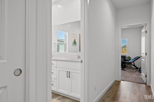 713 Winooski Ct, Bakersfield, CA 93314 - corridor featuring light wood-style floors and a sink
