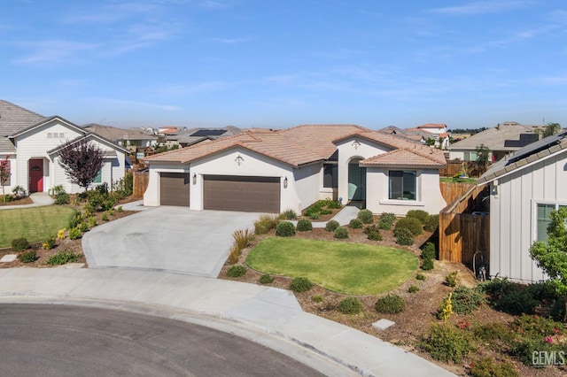 713 Winooski Ct, Bakersfield, CA 93314 - mediterranean / spanish-style home with an attached garage, driveway, a residential view, stucco siding, and a tiled roof
