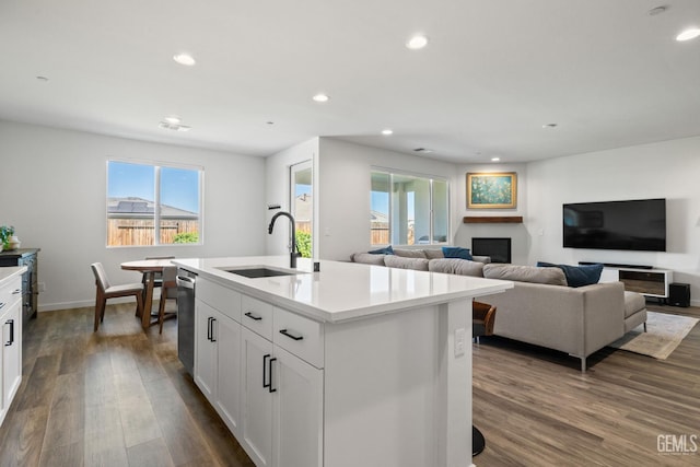 713 Winooski Ct, Bakersfield, CA 93314 - kitchen featuring dark wood finished floors, recessed lighting, light countertops, white cabinetry, and a center island with sink