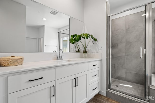 713 Winooski Ct, Bakersfield, CA 93314 - bathroom with vanity, a stall shower, and wood finished floors