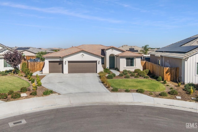 713 Winooski Ct, Bakersfield, CA 93314 - mediterranean / spanish-style house featuring a garage, concrete driveway, a tile roof, and stucco siding