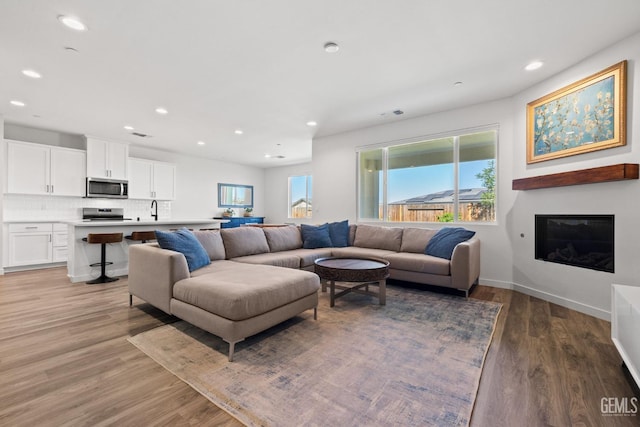 713 Winooski Ct, Bakersfield, CA 93314 - living area featuring light wood-style flooring, recessed lighting, and a glass covered fireplace