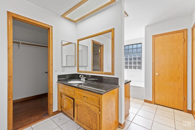 631 Faversham Way, Bakersfield, CA 93311 - full bath featuring vanity, tile patterned flooring, a bathtub, and baseboards