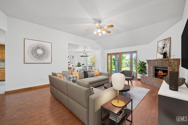 631 Faversham Way, Bakersfield, CA 93311 - living area with a brick fireplace, vaulted ceiling, a ceiling fan, dark wood-style floors, and a chandelier