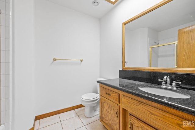 631 Faversham Way, Bakersfield, CA 93311 - bathroom featuring vanity, tiled shower, toilet, tile patterned floors, and baseboards