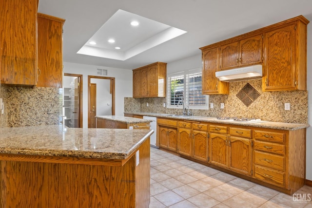 631 Faversham Way, Bakersfield, CA 93311 - kitchen featuring range hood, white appliances, a tray ceiling, brown cabinetry, and recessed lighting