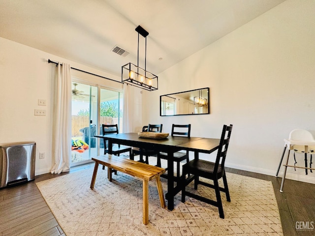 7303 Wild Mustang Dr, Bakersfield, CA 93311 - dining area featuring a chandelier, vaulted ceiling, and wood finished floors