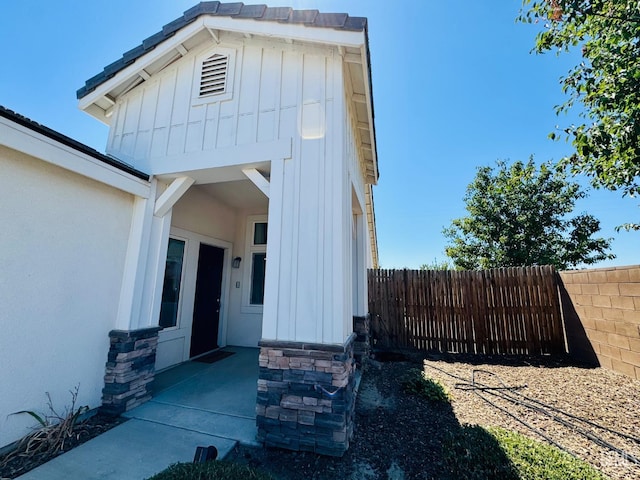 7303 Wild Mustang Dr, Bakersfield, CA 93311 - property entrance with board and batten siding and stone siding