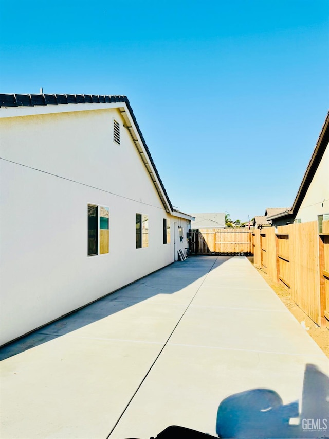 7303 Wild Mustang Dr, Bakersfield, CA 93311 - view of property exterior featuring stucco siding, a fenced backyard, and a patio area