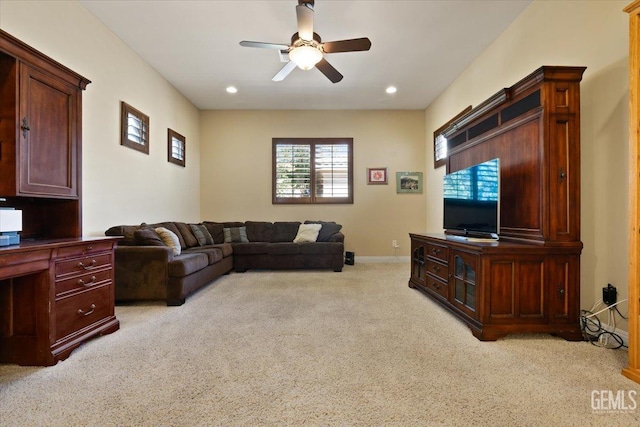 living area featuring a ceiling fan, recessed lighting, light colored carpet, and baseboards