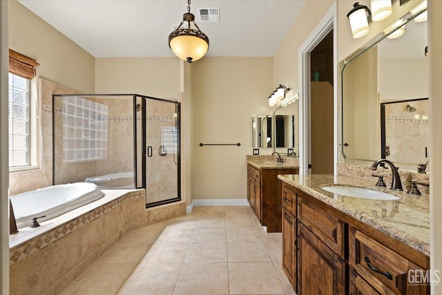 bathroom featuring a sink, a garden tub, a stall shower, and tile patterned floors